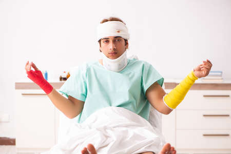 Young injured man staying in the hospitalの写真素材