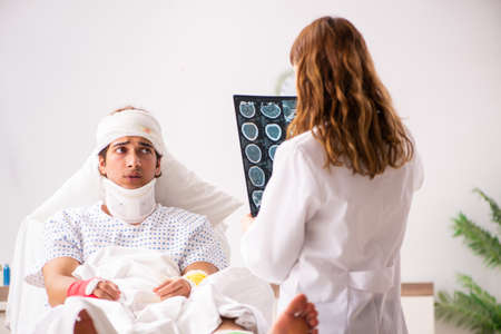 Young doctor examining injured patientの写真素材