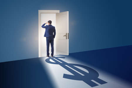 Businessman casting shadow in dollar shapeの写真素材