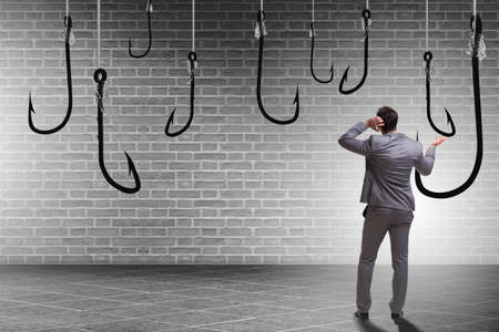 Businessman being tempted to bite the baitの写真素材