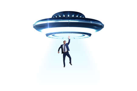 Flying saucer abducting young businessmanの写真素材