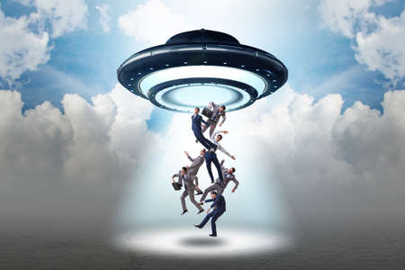 Flying saucer abducting young businessmanの写真素材