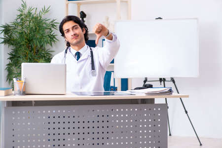 Young handsome doctor working in clinicの写真素材