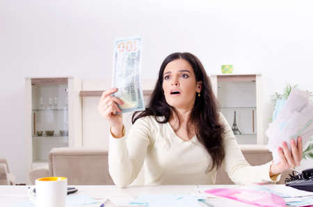 Young woman with receipts in budget planning concept