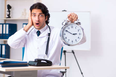 Young handsome doctor working in clinicの写真素材