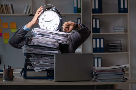 Young male employee working late at office