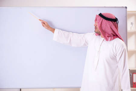 Arab teacher in front of whiteboardの写真素材