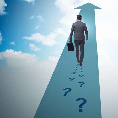 Businessman walking away on question footpathの写真素材