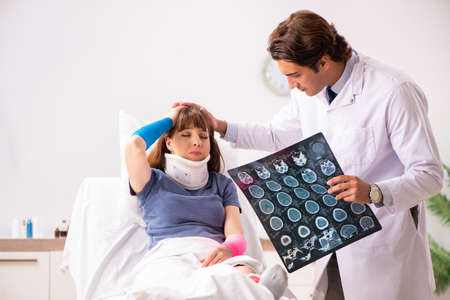 Young doctor examining injured patientの写真素材