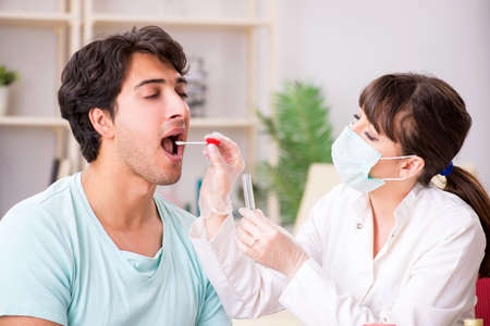 Doctor getting saliva test sample in clinic hospital