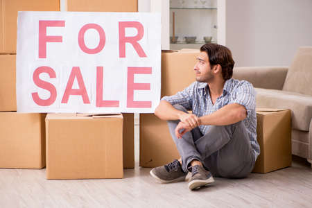Young man offering home for sale and moving out