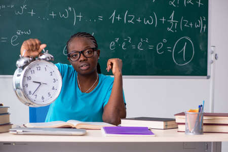Black female student in front of chalkboardの写真素材