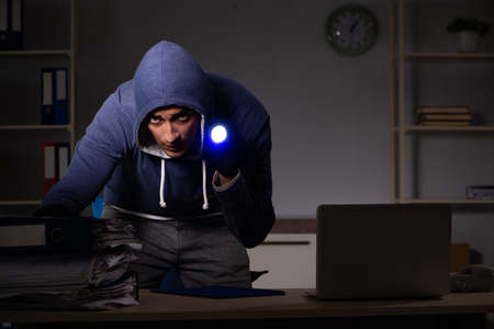 Thief trying to steal personal data in identity theft conceptの写真素材