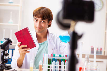 Chemist blogger recording video for his blogの写真素材