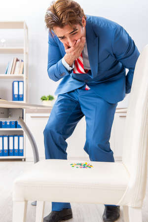 Office prank with sharp thumbtacks on chairの写真素材