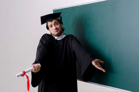 Graduate student in front of green board