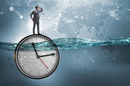 Businessman in deadline and time management conceptの写真素材