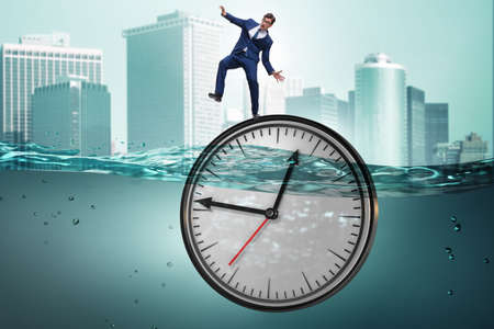 Businessman in deadline and time management concept