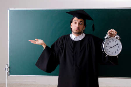 Graduate student in front of green board