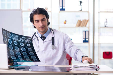 Young handsome male radiologist in front of whiteboard