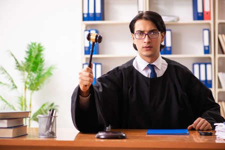Young handsome judge working in courtの写真素材