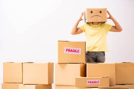 Unhappy man with box instead of his headの写真素材