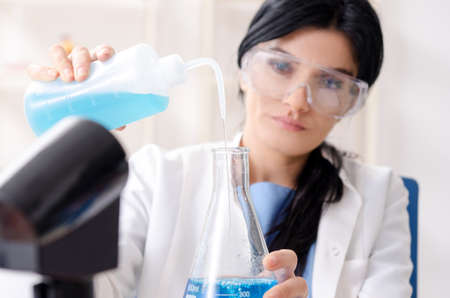 Female chemist working at the lab