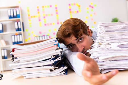 Young employee suffering from excessive work
