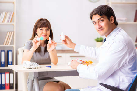 Young woman visiting male doctor ophthalmologist in hospital