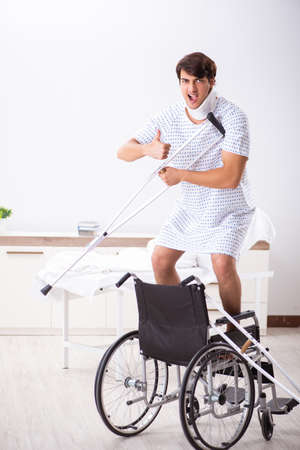 Young handsome man in wheelchair at the hospitalの写真素材