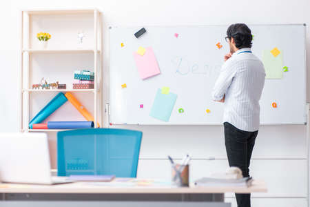 Young handsome male designer working in the officeの写真素材