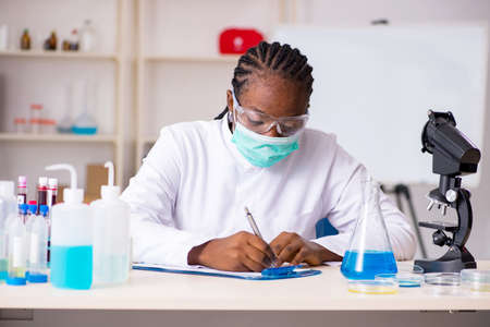 Young black chemist working in the lab