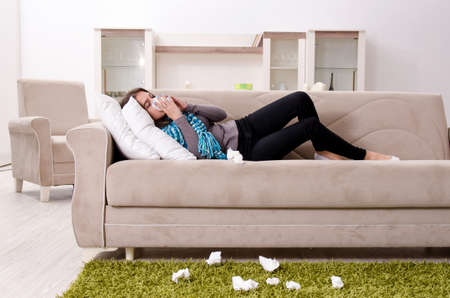 Sick young woman suffering at homeの写真素材