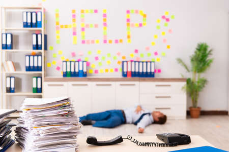 Young employee suffering from excessive work
