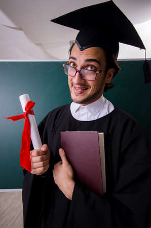 Graduate student in front of green boardの写真素材