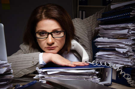 Female employee suffering from excessive workの写真素材