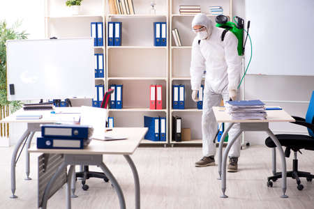 Professional contractor doing pest control at officeの写真素材