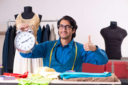 Young male tailor working at workshop