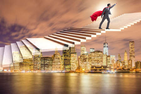 Superhero businessman climbing career ladderの写真素材