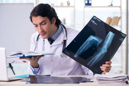 Young handsome male radiologist in front of whiteboard