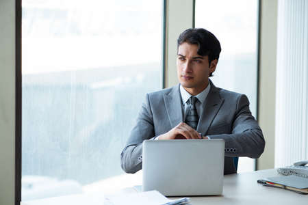 Young successful businessman working at the office