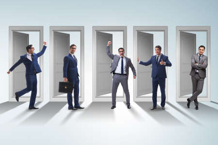 Businessman in uncertainty concept with many doorsの写真素材