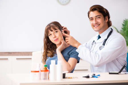 Patient with hearing problem visiting doctor otorhinolaryngologiの写真素材