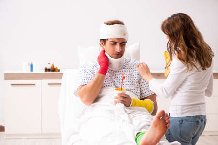 Loving wife looking after injured husbandの写真素材