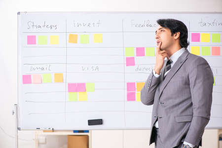 Young handsome employee working in the officeの写真素材