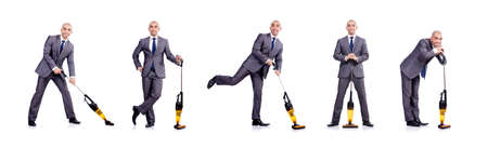 Businessman doing vacuum cleaning on whiteの写真素材