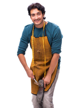 Young handsome shoemaker isolated on whiteの写真素材