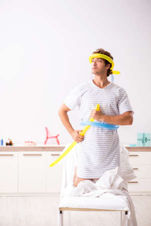 Young man celebrating his birthday in hospitalの写真素材