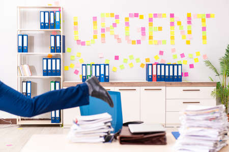 Young employee suffering from excessive work
