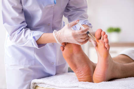 Podiatrist treating feet during procedureの写真素材